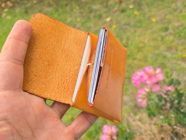 Honey coloured wallet in hand